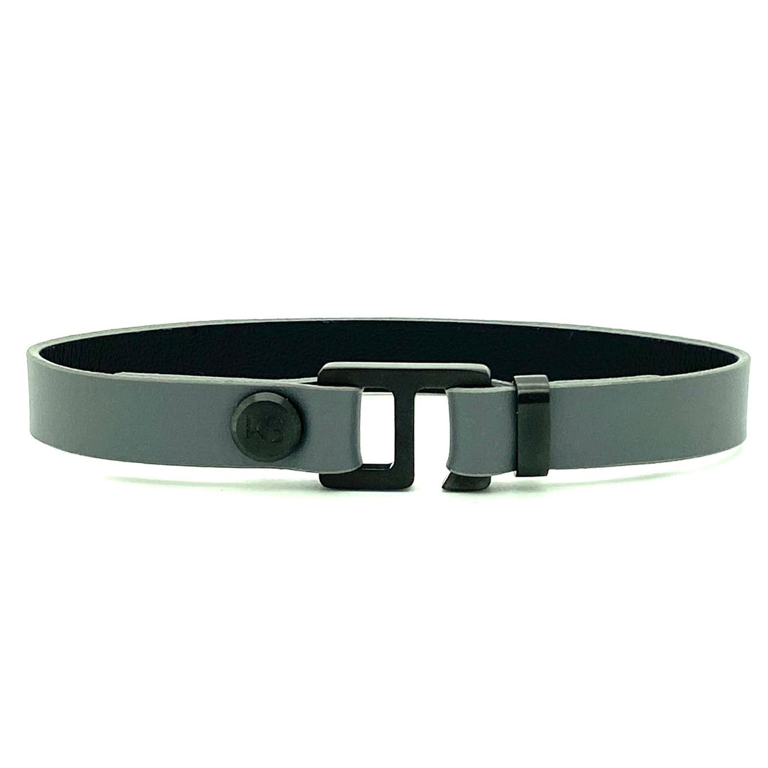 With a trendy, cool modern vibe, this charcoal grey/navy blue leather cuff bracelet is paired with your choice of brushed stainless steel, brass or black ceramic hardware. Our signature cuff bracelet is a modern staple for your WristBend collection. Made by WristBend