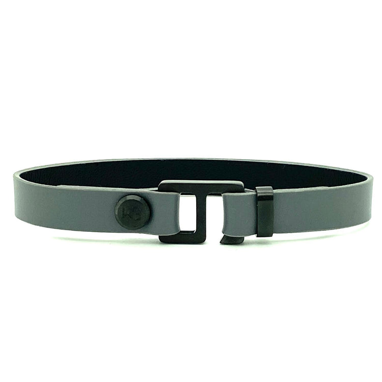 With a trendy, cool modern vibe, this charcoal grey/navy blue leather cuff bracelet is paired with your choice of brushed stainless steel, brass or black ceramic hardware. Our signature cuff bracelet is a modern staple for your WristBend collection. Made by WristBend