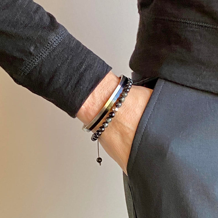 Cat's Eye beads act to stimulate intuition and to enhance protective energy. These smooth Cat's Eye beads are accented with your choice of 14K white, rose and yellow gold beads. Hand knotted adjustable cord for a perfect fit. Made by WristBend
