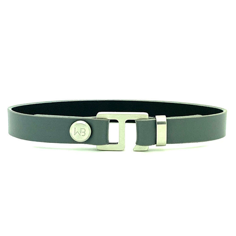 With a trendy, cool modern vibe, this charcoal grey/navy blue leather cuff bracelet is paired with your choice of brushed stainless steel, brass or black ceramic hardware. Our signature cuff bracelet is a modern staple for your WristBend collection. Made by WristBend