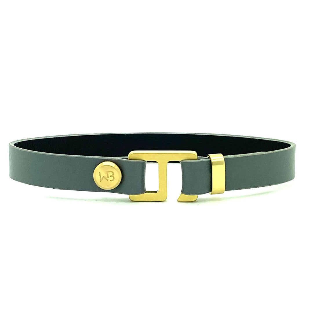 With a trendy, cool modern vibe, this charcoal grey/navy blue leather cuff bracelet is paired with your choice of brushed stainless steel, brass or black ceramic hardware. Our signature cuff bracelet is a modern staple for your WristBend collection. Made by WristBend