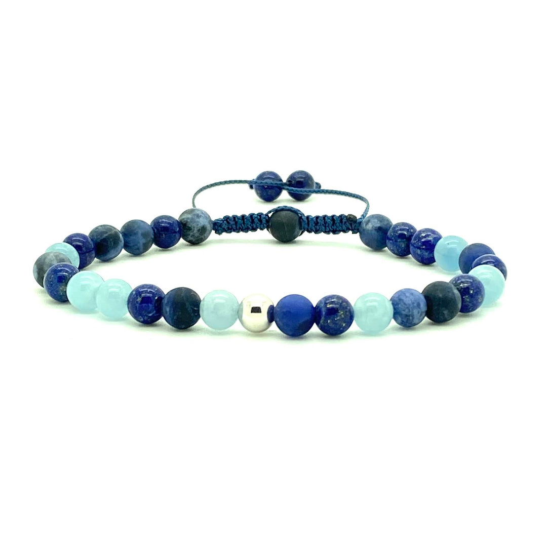 Sodalite is a stunning semi-precious stone that has the power to heal, protect, and produce positive energy. Accented with assorted gemstone beads and your choice of two 14K solid white, rose or yellow gold bead. Hand knotted adjustable cord for a perfect fit. Made by WristBend
