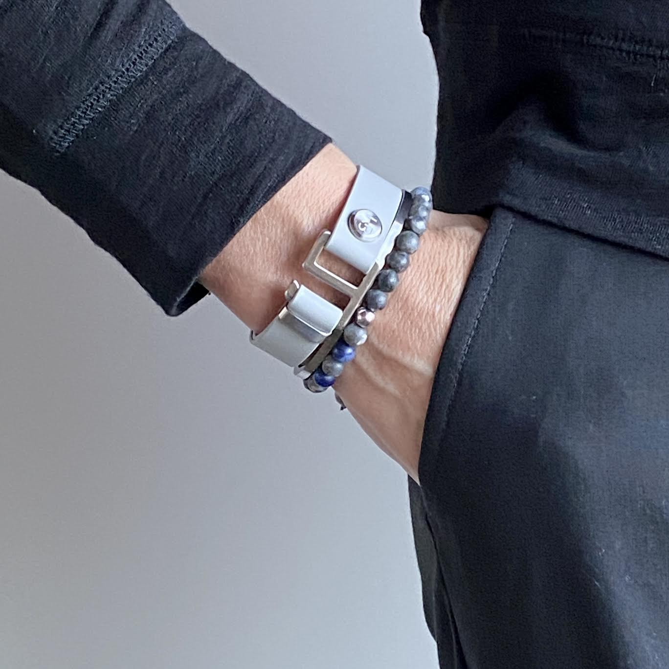 Our striking smoke grey leather cuff bracelet is paired perfectly with our artisan designed hardware. Choice includes rose gold, yellow gold, stainless steel or black ceramic. This adjustable size bracelet is a distinctive piece worn alone or with a WristBend stacking bracelet. Made by WristBend