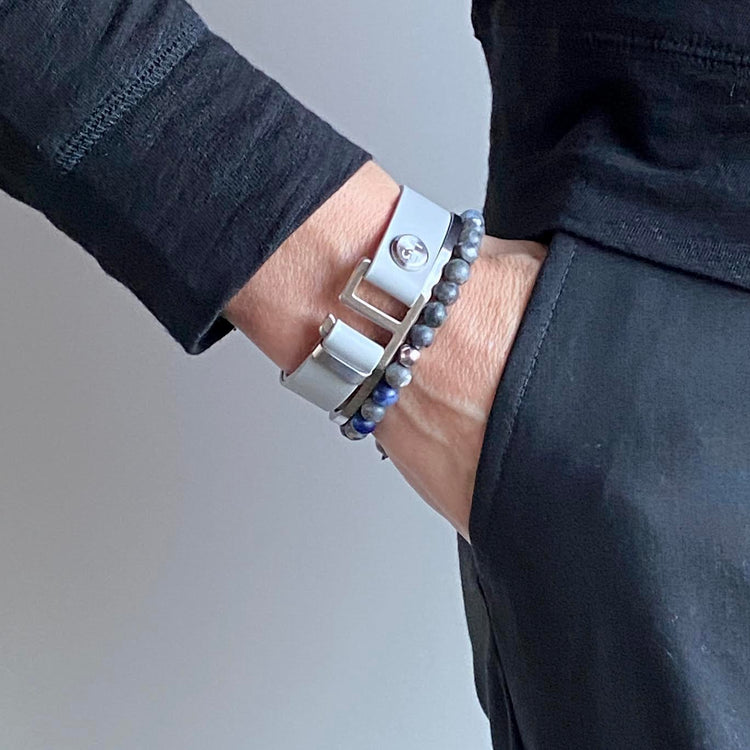 Our striking smoke grey leather cuff bracelet is paired perfectly with our artisan designed hardware. Choice includes rose gold, yellow gold, stainless steel or black ceramic. This adjustable size bracelet is a distinctive piece worn alone or with a WristBend stacking bracelet. Made by WristBend