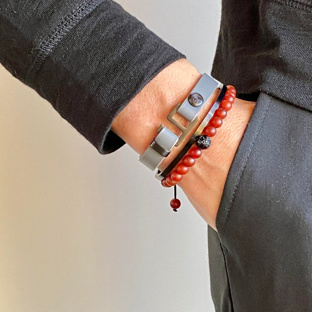 With a trendy, cool modern vibe, this charcoal grey/navy blue leather cuff bracelet is paired with your choice of brushed stainless steel, brass or black ceramic hardware. Our signature cuff bracelet is a modern staple for your WristBend collection. Made by WristBend