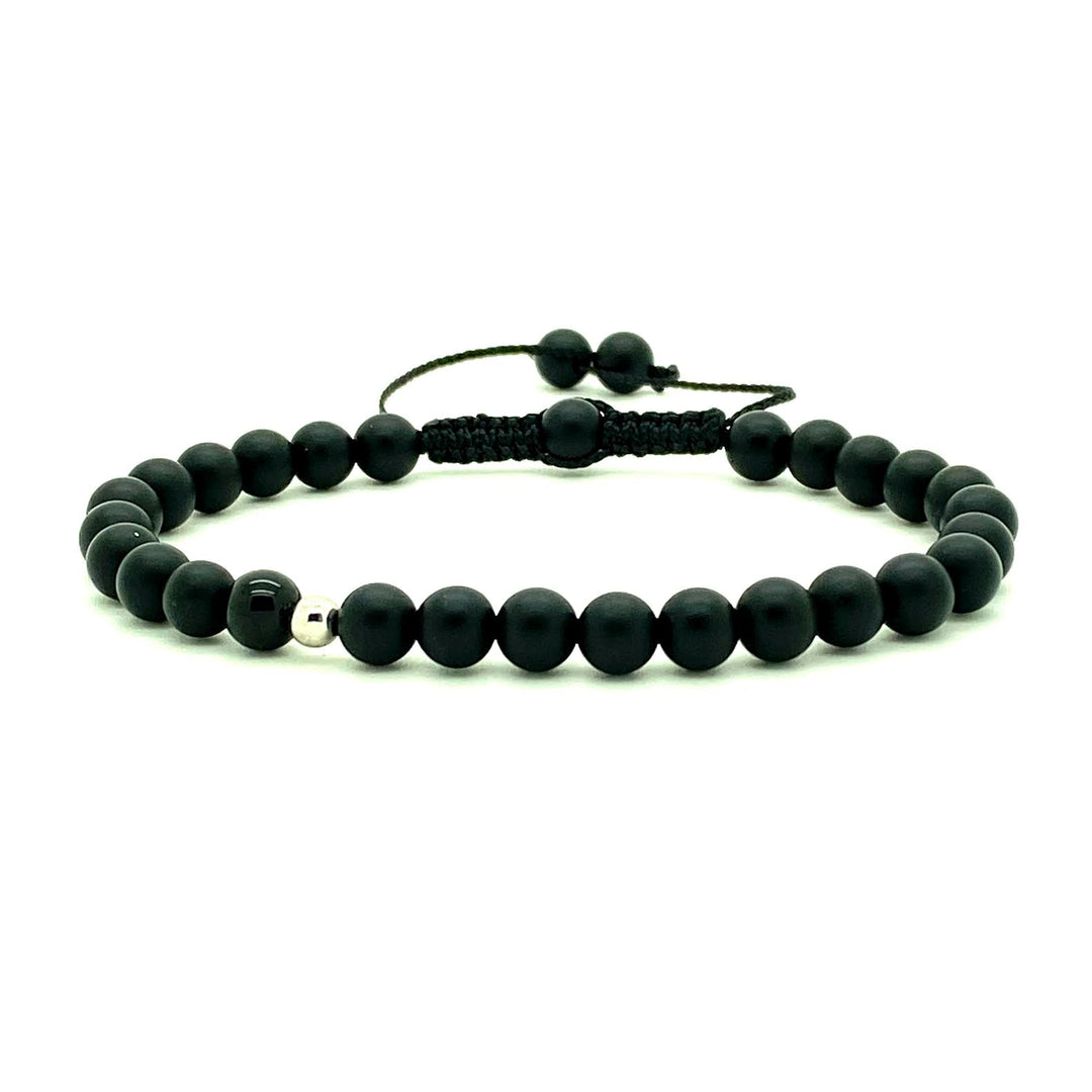 Trendy black matte onyx beads accented with a single black spinel bead, and your choice of a 14K solid white, rose or yellow gold bead. Hand knotted adjustable cord for a perfect fit. Made by WristBend
