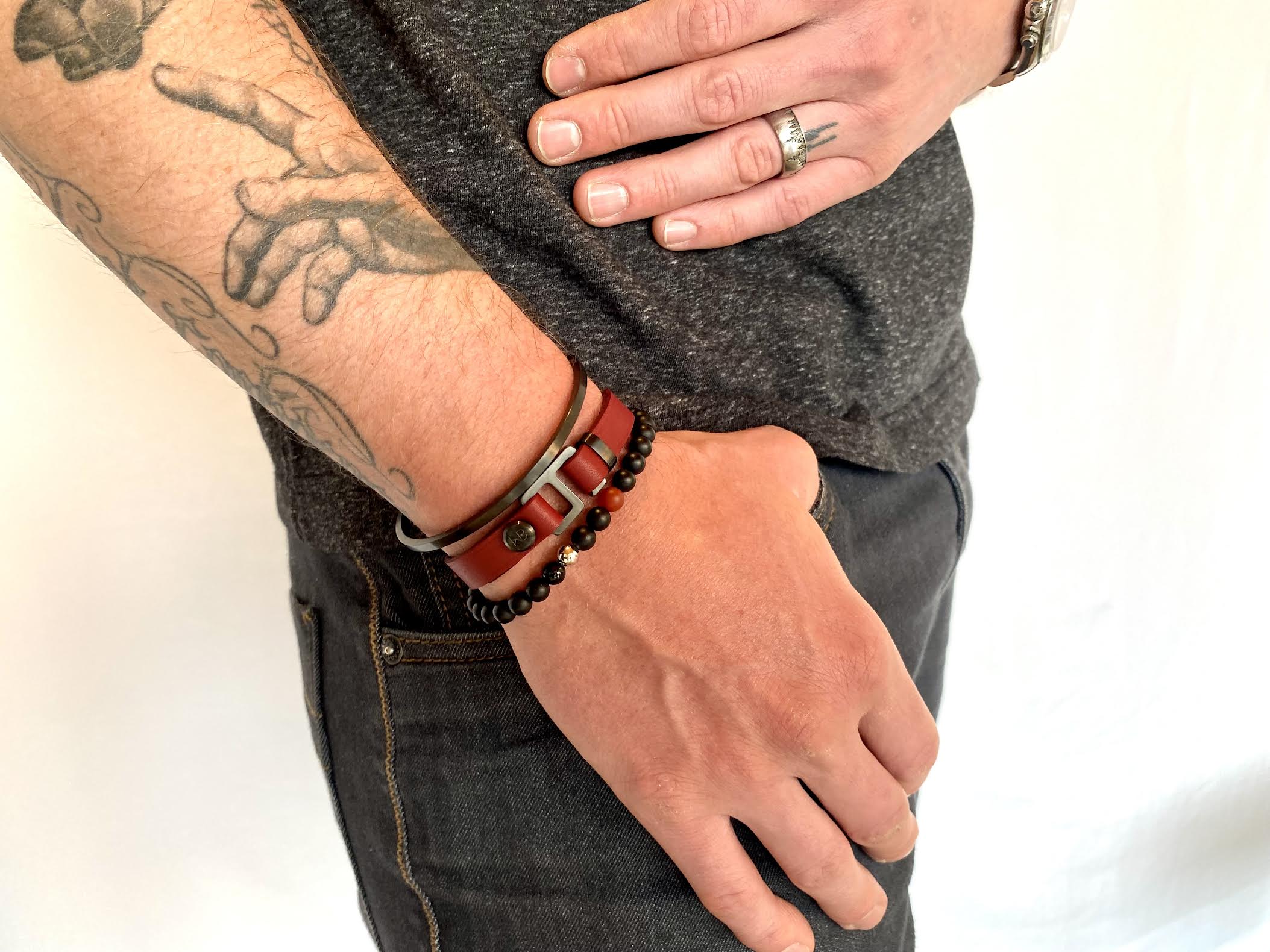 With a trendy, cool modern vibe, this burgundy/black Italian leather cuff bracelet is paired with your choice of brushed stainless steel, brass or black ceramic hardware. Our signature cuff bracelet is a modern staple for your WristBend collection. Made by WristBend