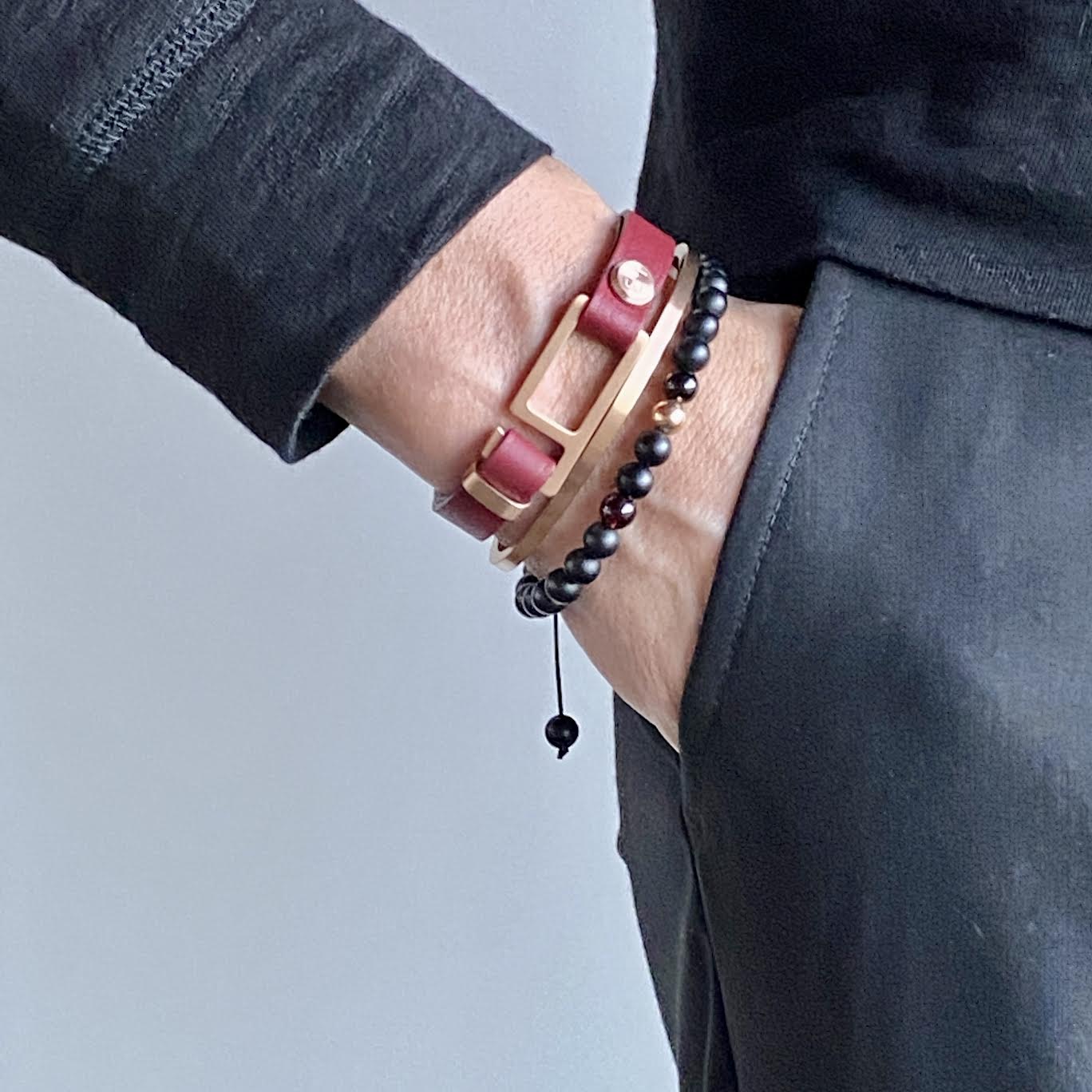 Our striking burgundy/black Italian leather bracelet is paired perfectly with our artisan designed, lightly brushed hardware. Your hardware choices include Rose Gold, Yellow Gold, Stainless Steel or Black Ceramic. This adjustable size bracelet is a distinctive piece worn alone or with a WristBend stacking bracelet. Made by WristBend