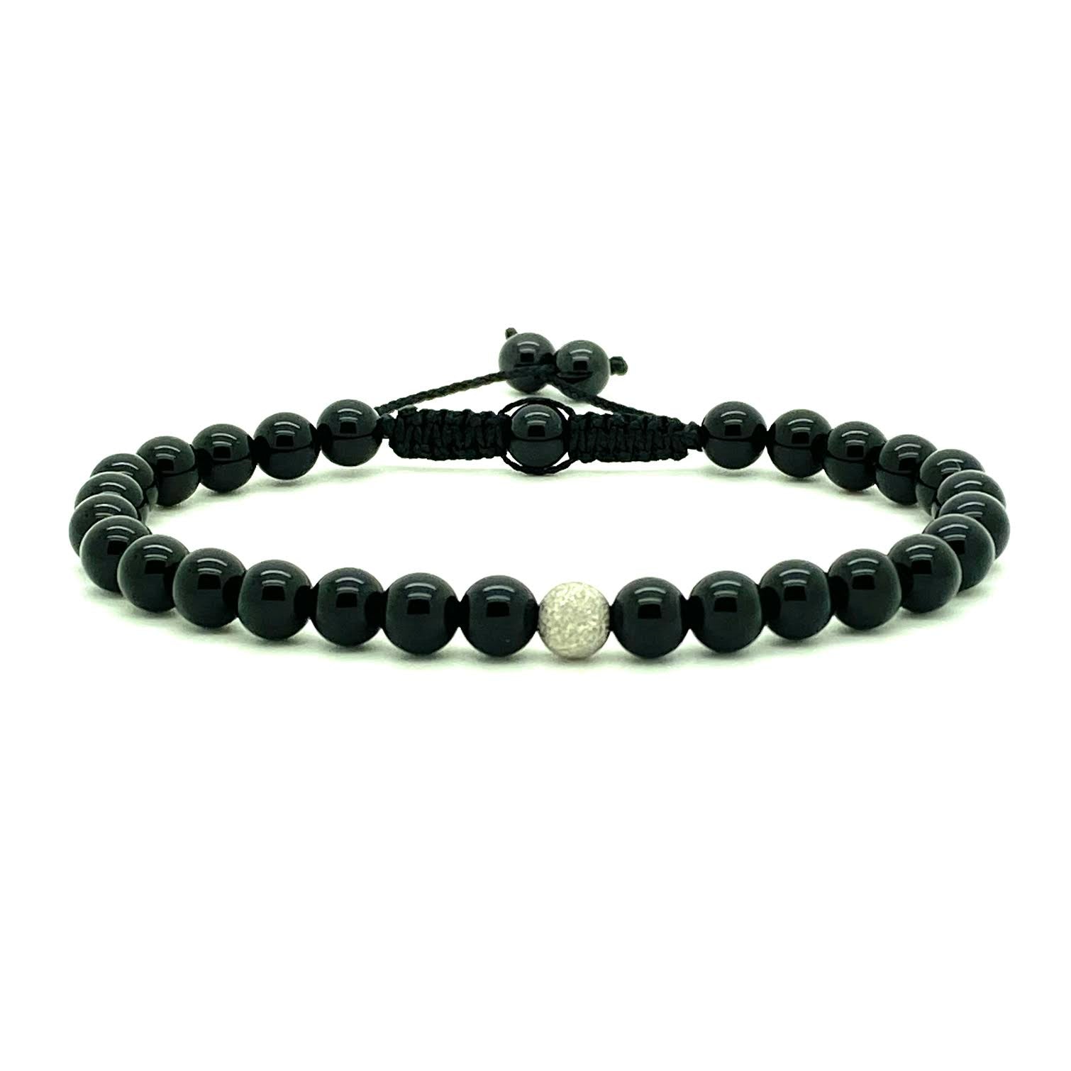 Sophisticated black onyx beads accented with one stardust white gold bead. Hand knotted adjustable cord for a perfect fit. Made by WristBend