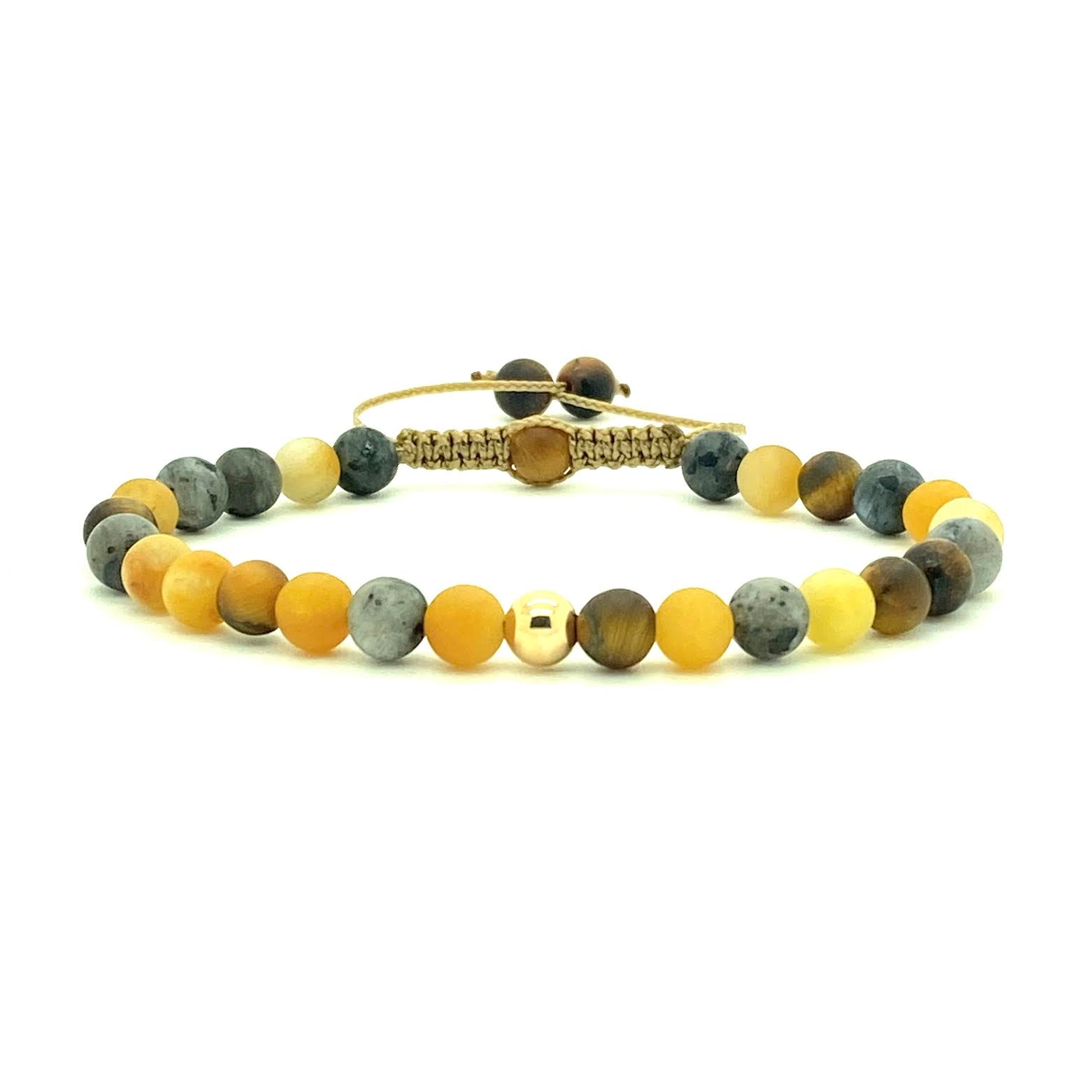 Tiger's Eye is a stunning semi-precious stone that has the power to heal, protect, and produce positive energy. Accented with yellow jade beads and your choice of two 14K solid white, rose or yellow gold bead. Hand knotted adjustable cord for a perfect fit. Made by WristBend