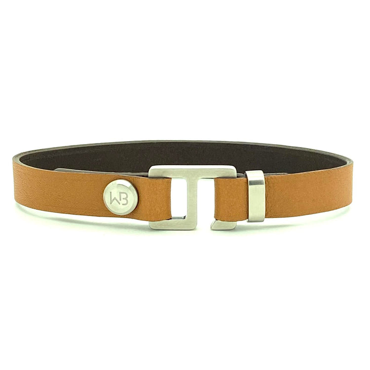With a trendy, cool modern vibe, this tan/dark brown Italian leather cuff bracelet is paired with your choice of brushed stainless steel, brass or black ceramic hardware. Our signature cuff bracelet is a modern staple for your WristBend collection. Made by WristBend