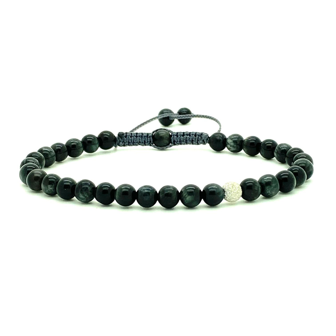 Cat's Eye beads act to stimulate intuition and to enhance protective energy. These smooth Cat's Eye beads are accented with a single white gold stardust bead. Hand knotted adjustable cord for a perfect fit. Made by WristBend