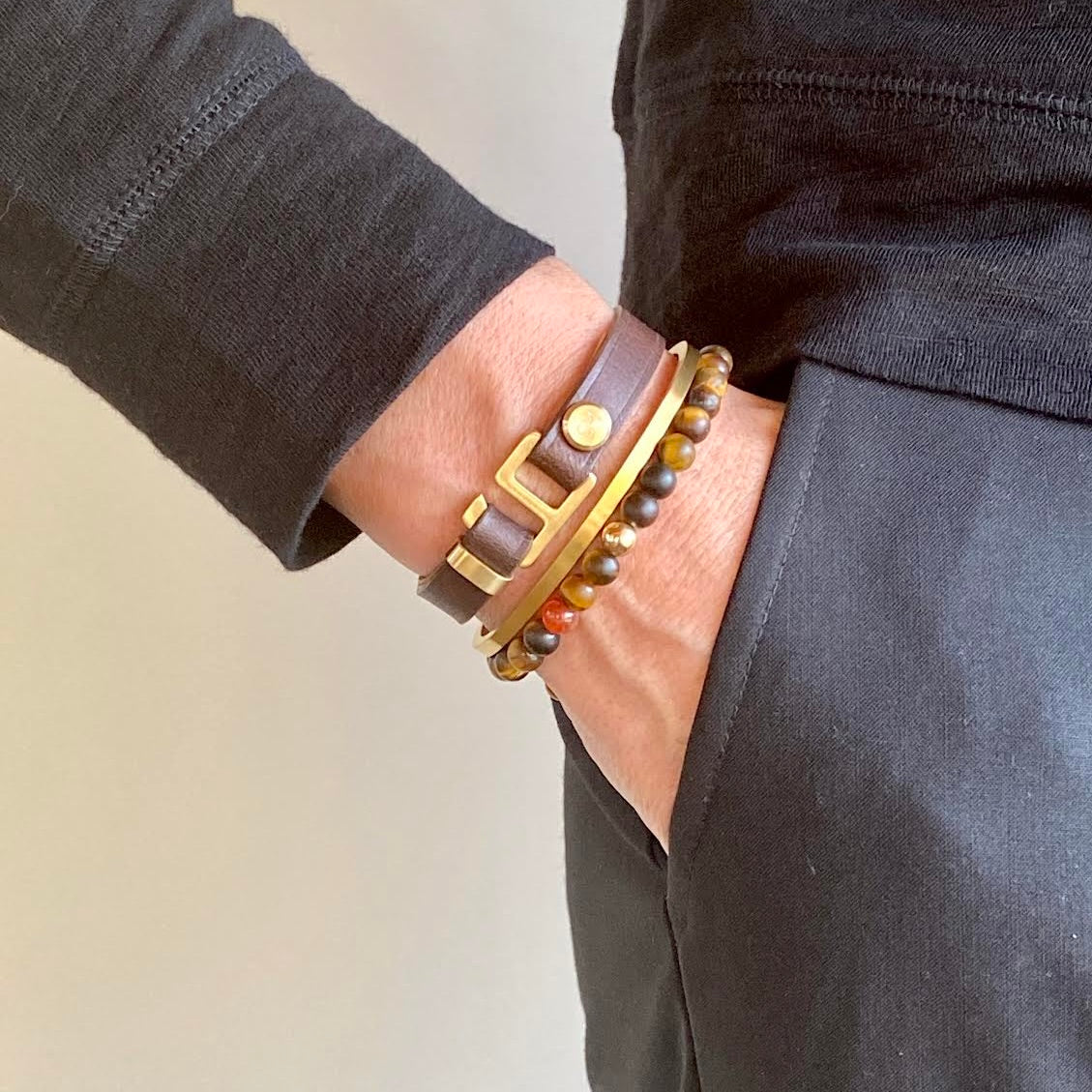 With a trendy, cool modern vibe, this dark brown/tan Italian leather cuff bracelet is paired with your choice of brushed stainless steel or black ceramic hardware. Our signature cuff bracelet is a modern staple for your WristBend collection. Made by WristBend