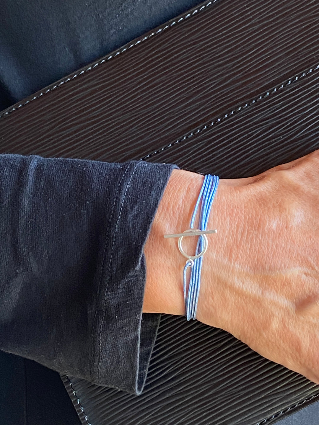 Cool handknotted adjustable cord bracelet with a sterling silver clasp. WristBend