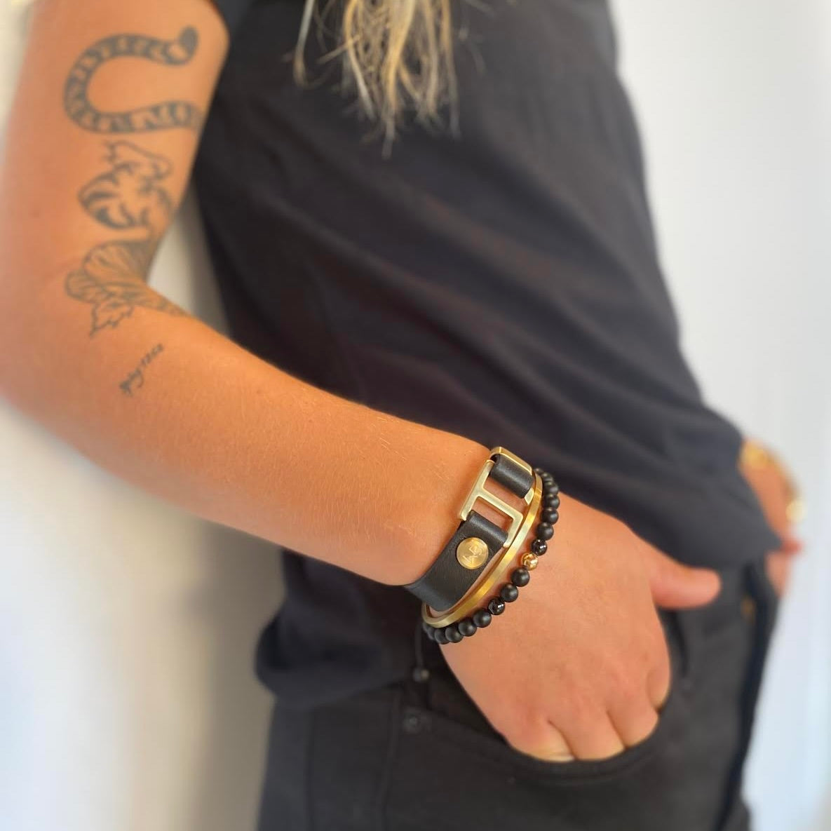 Our striking black Italian leather cuff bracelet is paired perfectly with our artisan designed hardware. Choice includes rose gold, yellow gold, stainless steel or black ceramic. This adjustable size bracelet is a distinctive piece worn alone or with a WristBend stacking bracelet. Made by WristBend